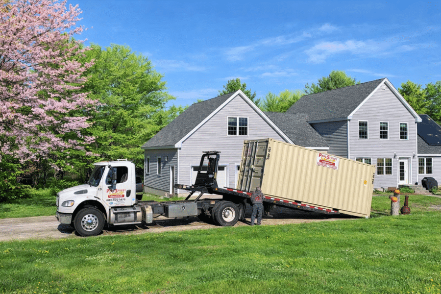 Page Street Leasing delivering a storage container to a residential driveway in New Hampshire